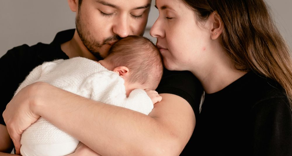 Photo by Carlos Santiago: https://www.pexels.com/photo/mother-and-father-standing-with-baby-15279474/