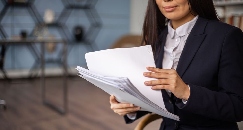 pexels-ekaterina-bolovtsova-6077648WEB_code and policies Photo by KATRIN BOLOVTSOVA: https://www.pexels.com/photo/woman-in-black-blazer-holding-white-papers-6077648/
